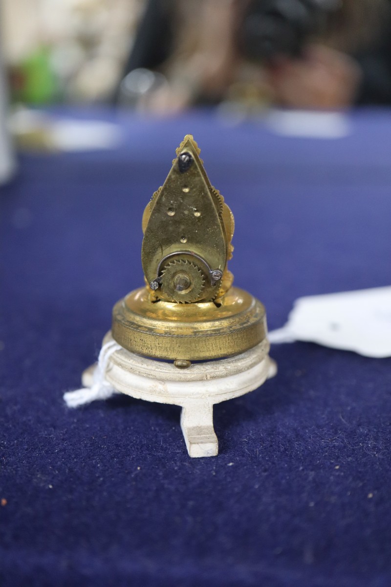 An Austrian miniature timepiece under a glass dome, overall height 5cm